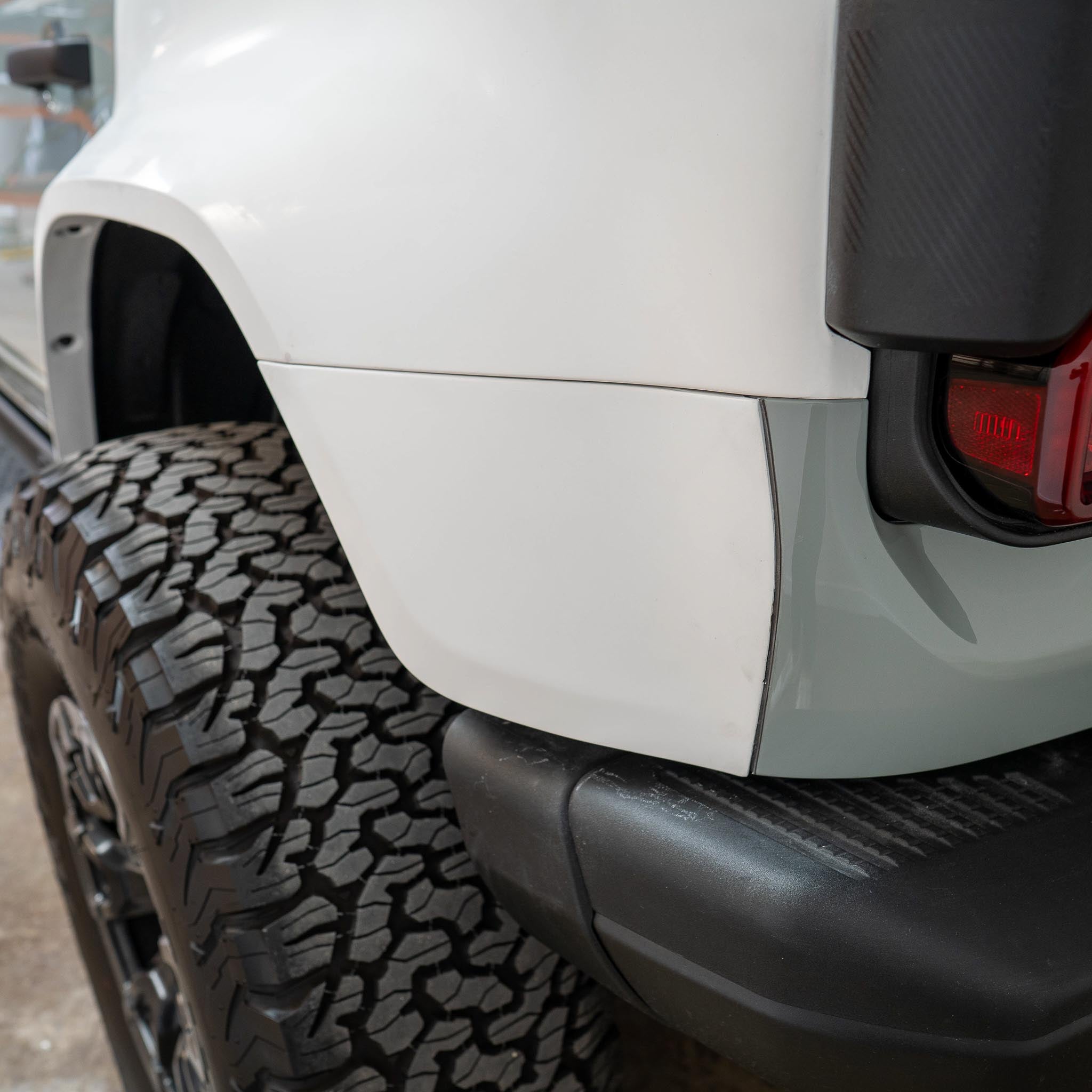 Rear quarter kit for 2022-2024 Ford Bronco Raptor, showcasing a sleek design and rugged tire compatibility.