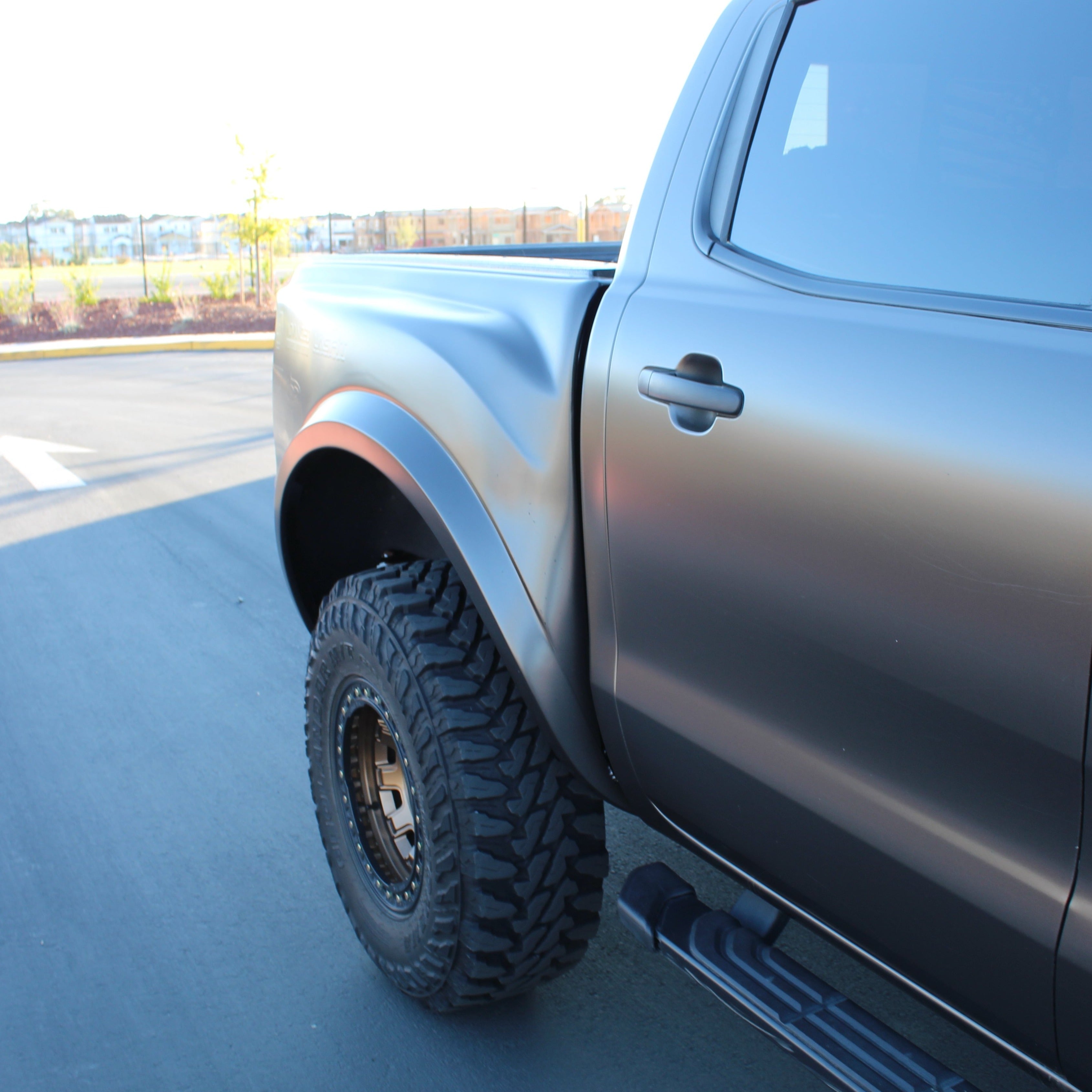 2019-2022 Ford Ranger with aftermarket bedsides, showcasing a rugged design and off-road tires for enhanced performance.