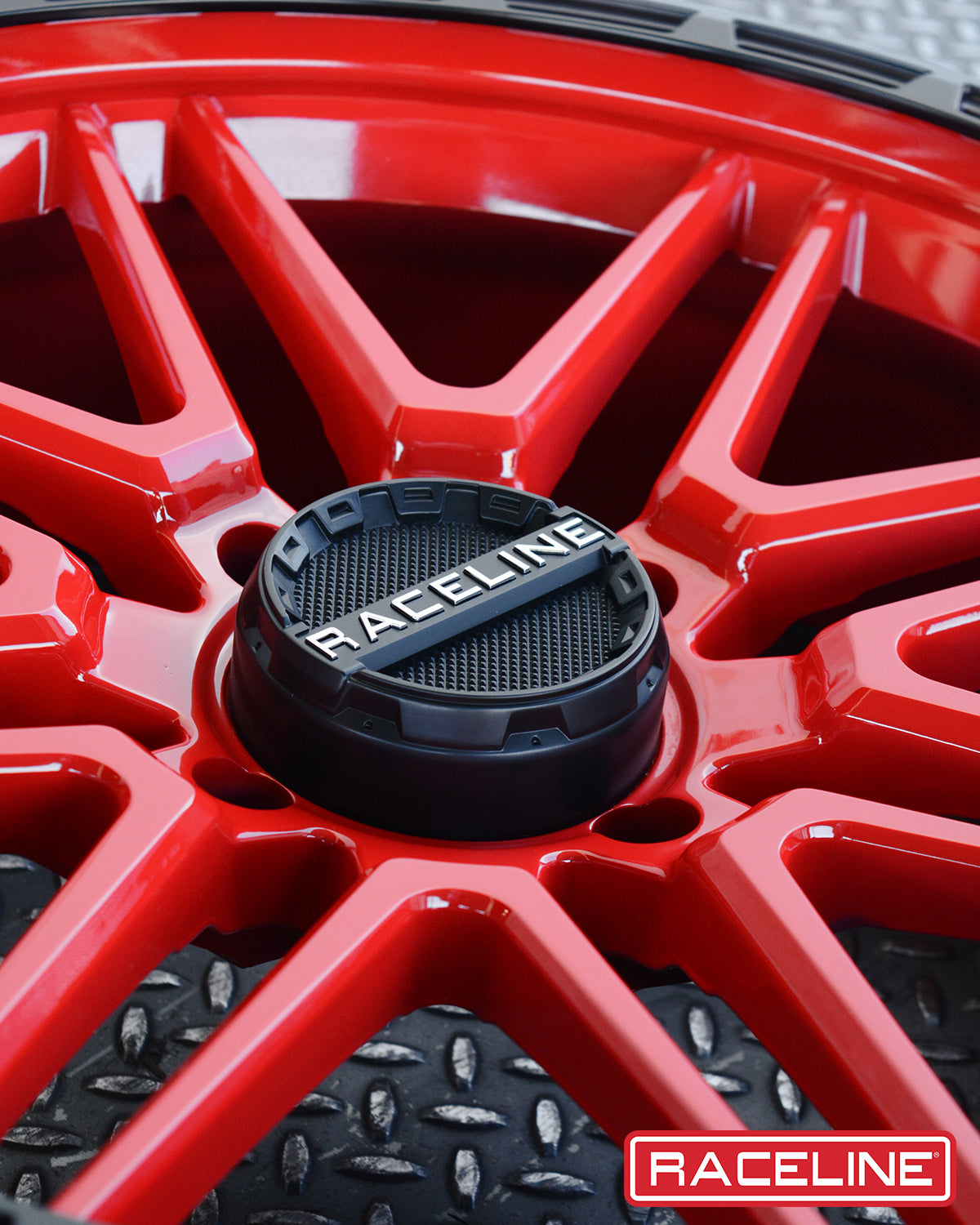 Red Raceline A11R Krank XL wheel with a detailed center cap, showcasing a modern design for off-road vehicles.