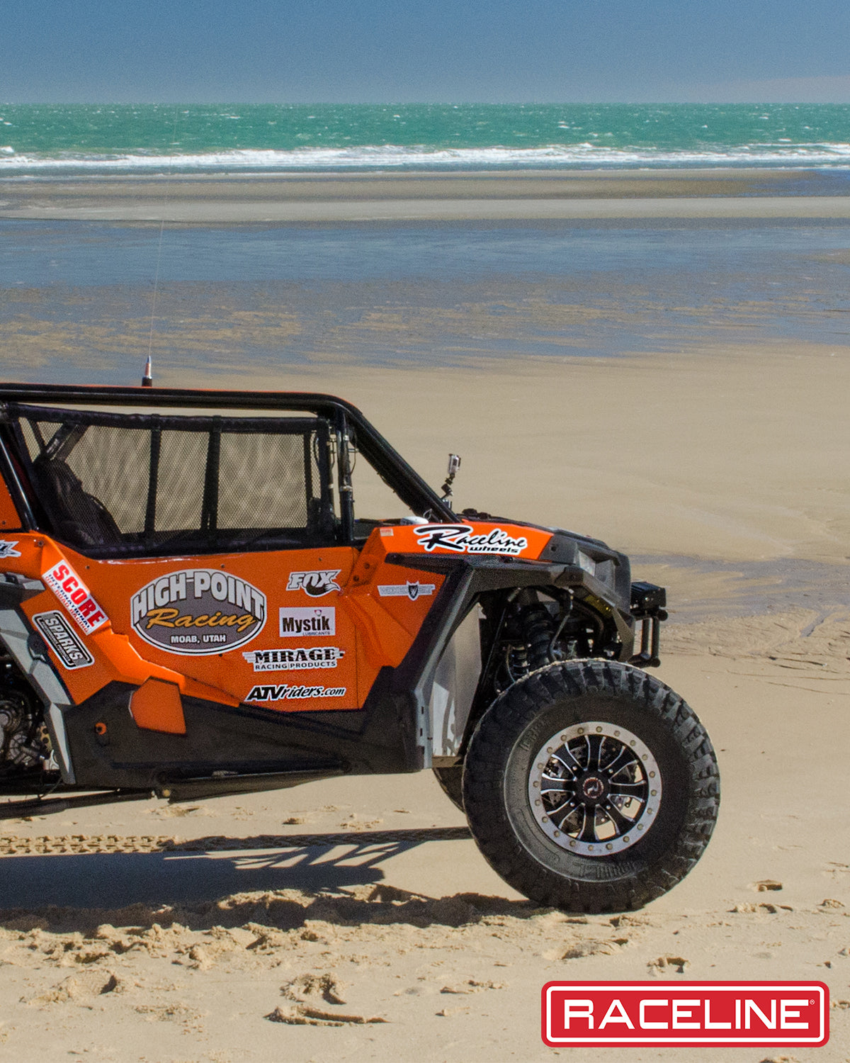 A71 Mamba Beadlock wheel mounted on a UTV, showcasing rugged design on a beach setting with ocean waves.
