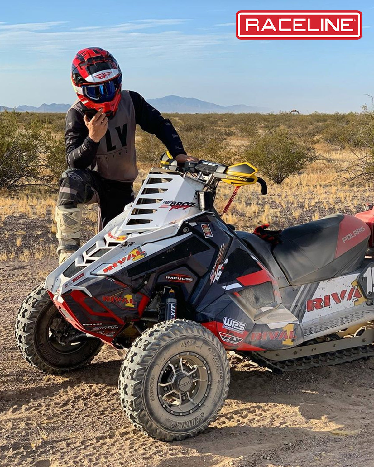 A77 Mamba off-road vehicle parked in a desert setting with a rider in protective gear, showcasing rugged terrain capabilities.