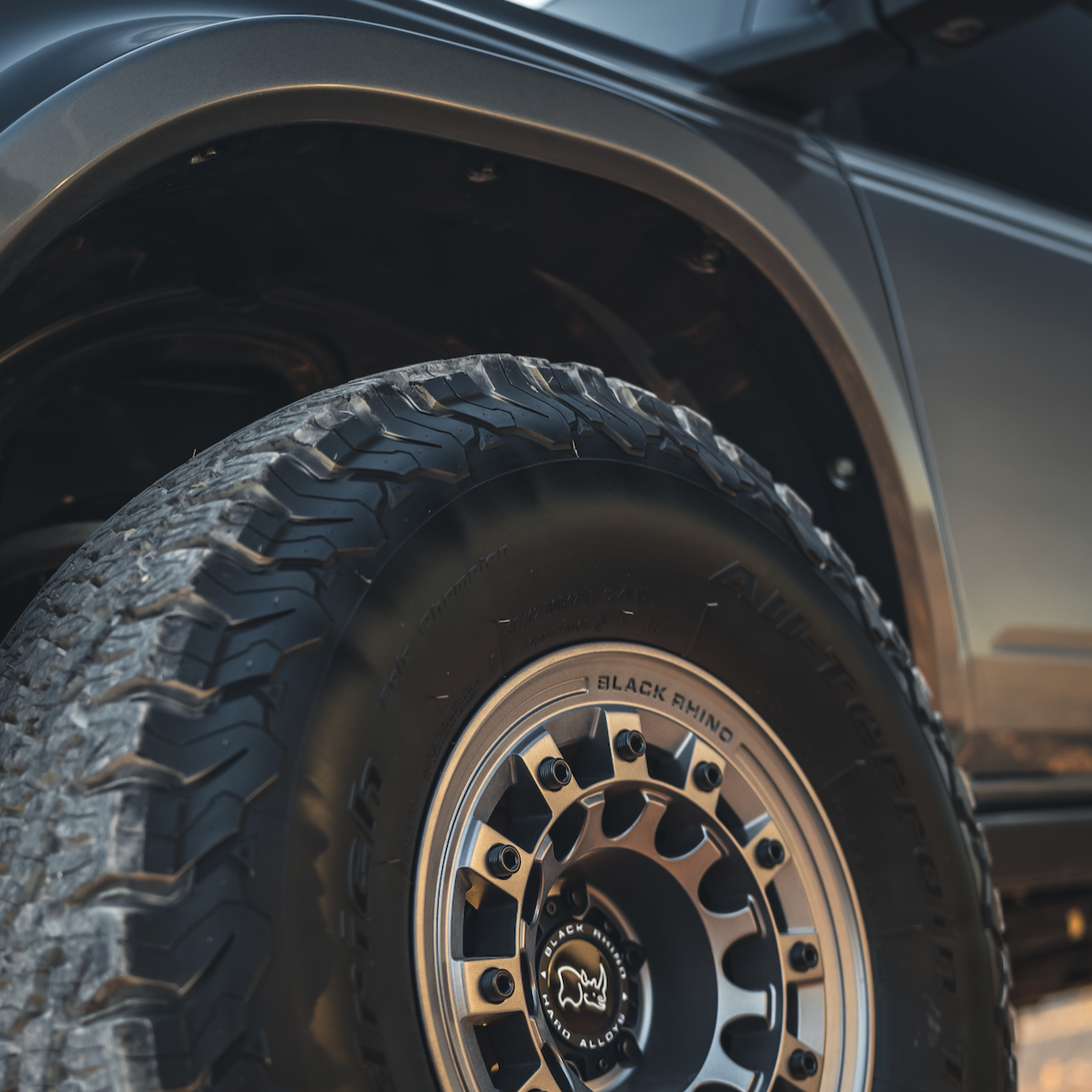Close-up of a 2021-2022 Ford Bronco fender and rugged tire, showcasing offroad capabilities and stylish design.