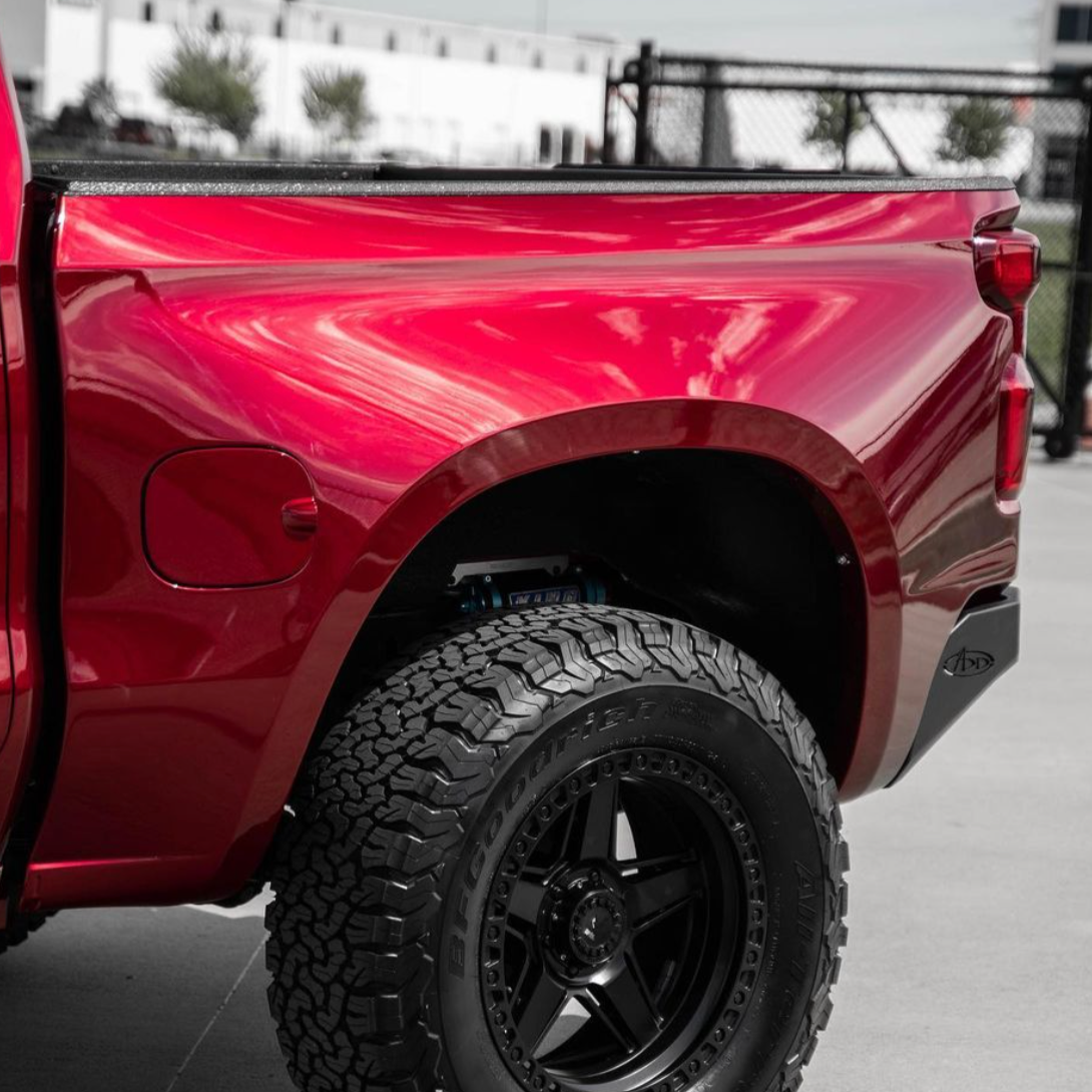 2019-2021 Chevrolet Silverado bedsides showcasing a sleek red finish and rugged offroad tire.