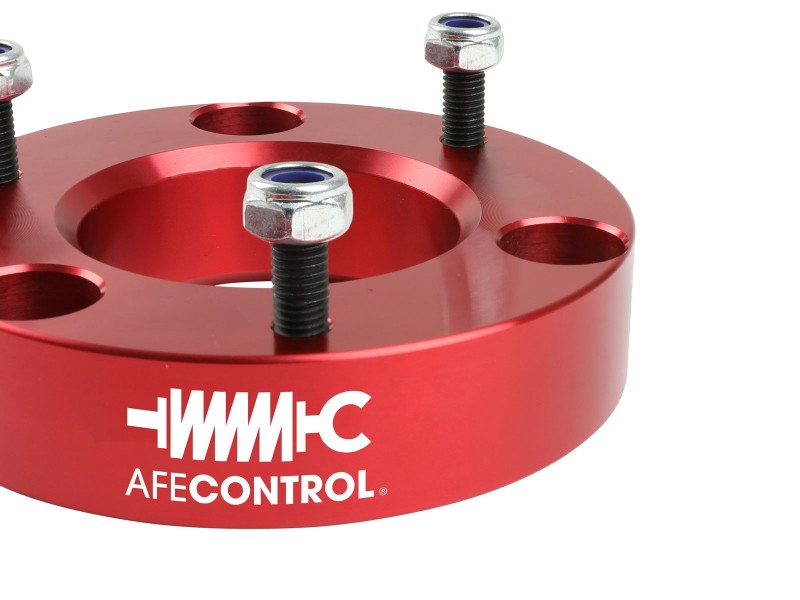 aFe CONTROL 2.0 IN Leveling Kit for 2004-2021 Ford F-150, featuring a red aluminum spacer with mounting hardware.