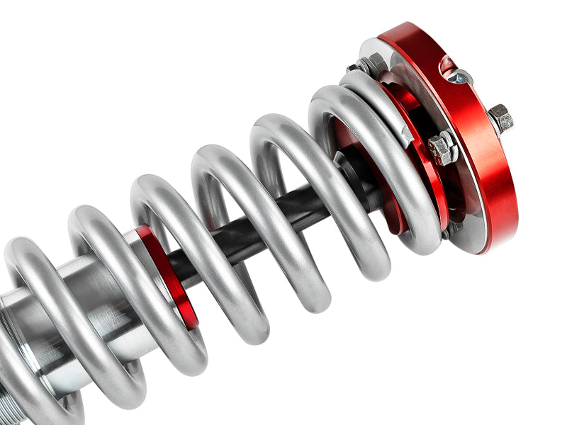 aFe Sway-A-Way 2.5in Front Coil Over Kit for 04-15 Nissan Titan featuring silver coil springs and red adjustment components.