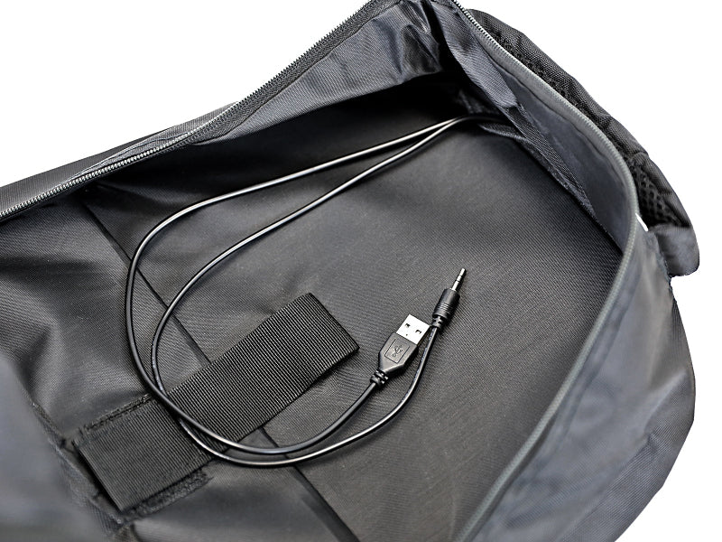 Interior view of aFe Power lightweight tactical backpack showing USB charging port and cable in black fabric.