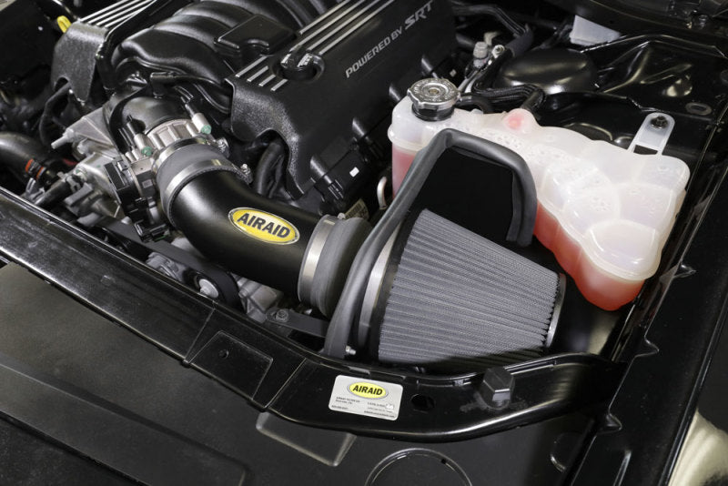 Airaid cold air intake kit installed in a Dodge Challenger V8 engine, enhancing airflow for improved performance.