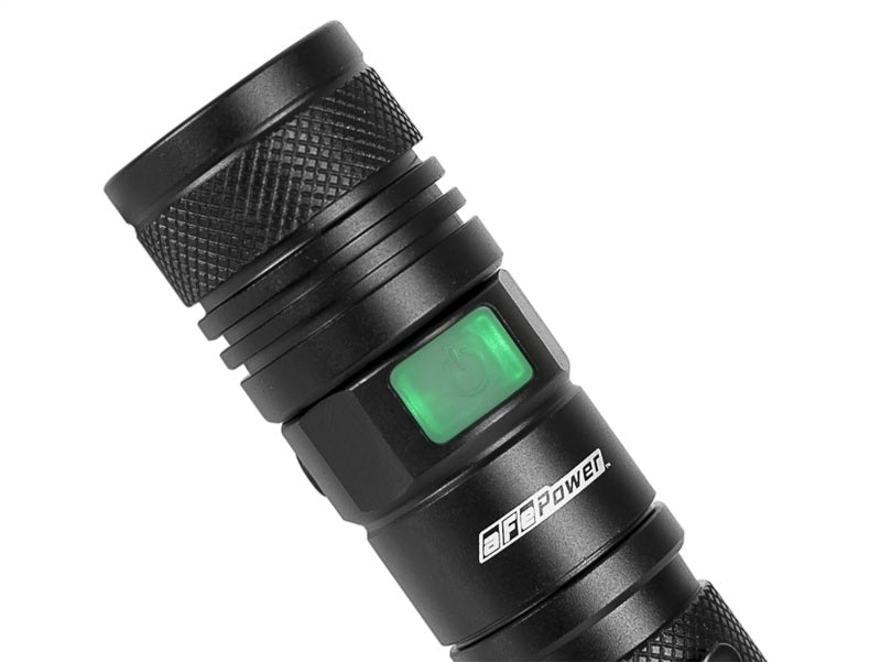 aFe Power LED flashlight with 950 lumens, featuring a textured grip and a green power button for easy operation.