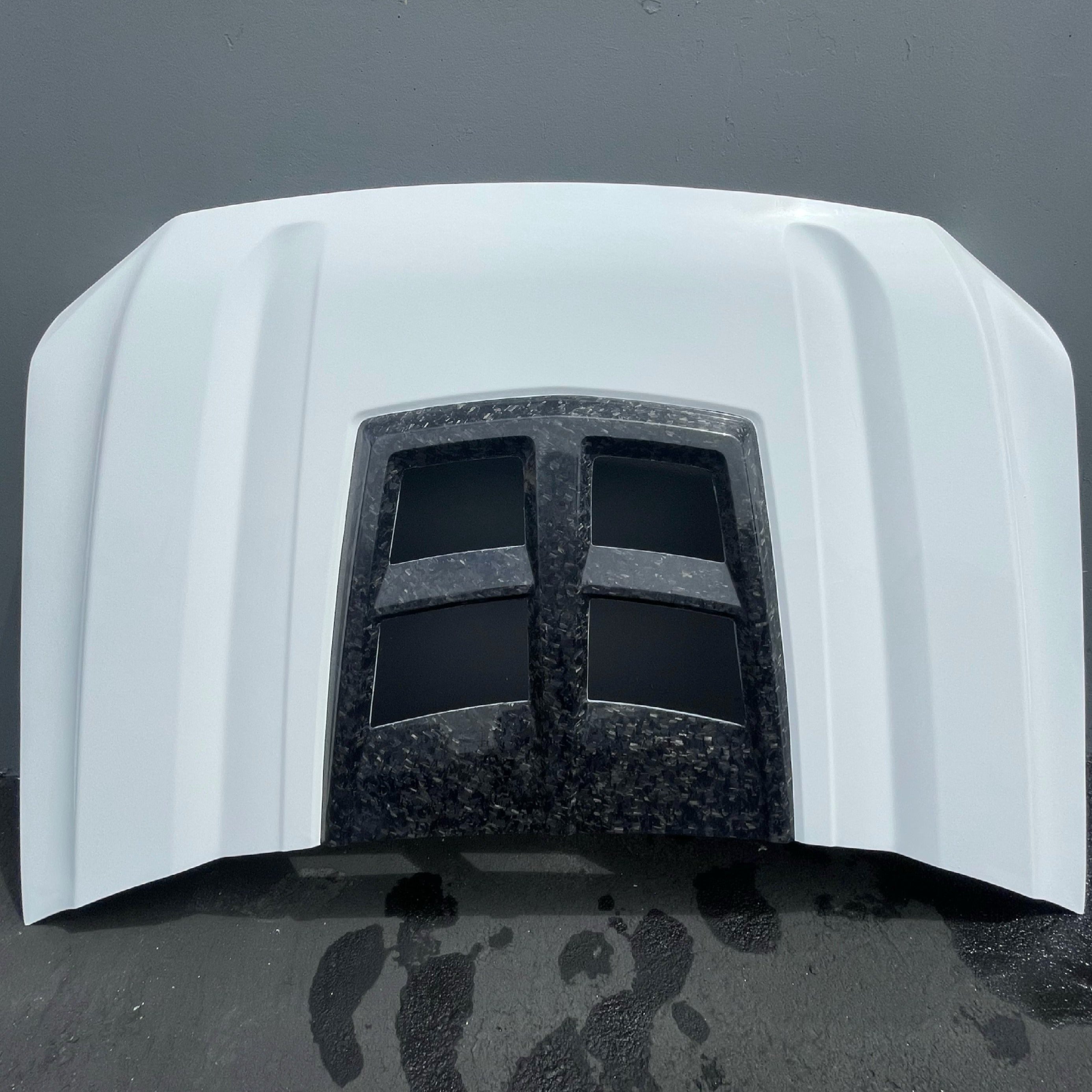 2019-2021 GMC Sierra hood featuring a sleek design with dual vents for improved airflow and performance.