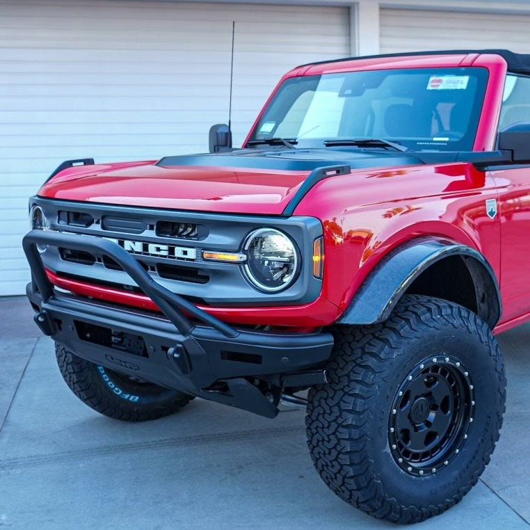 2021-2024 Ford Bronco with a heat extractor hood, showcasing a bold red exterior and rugged offroad tires.