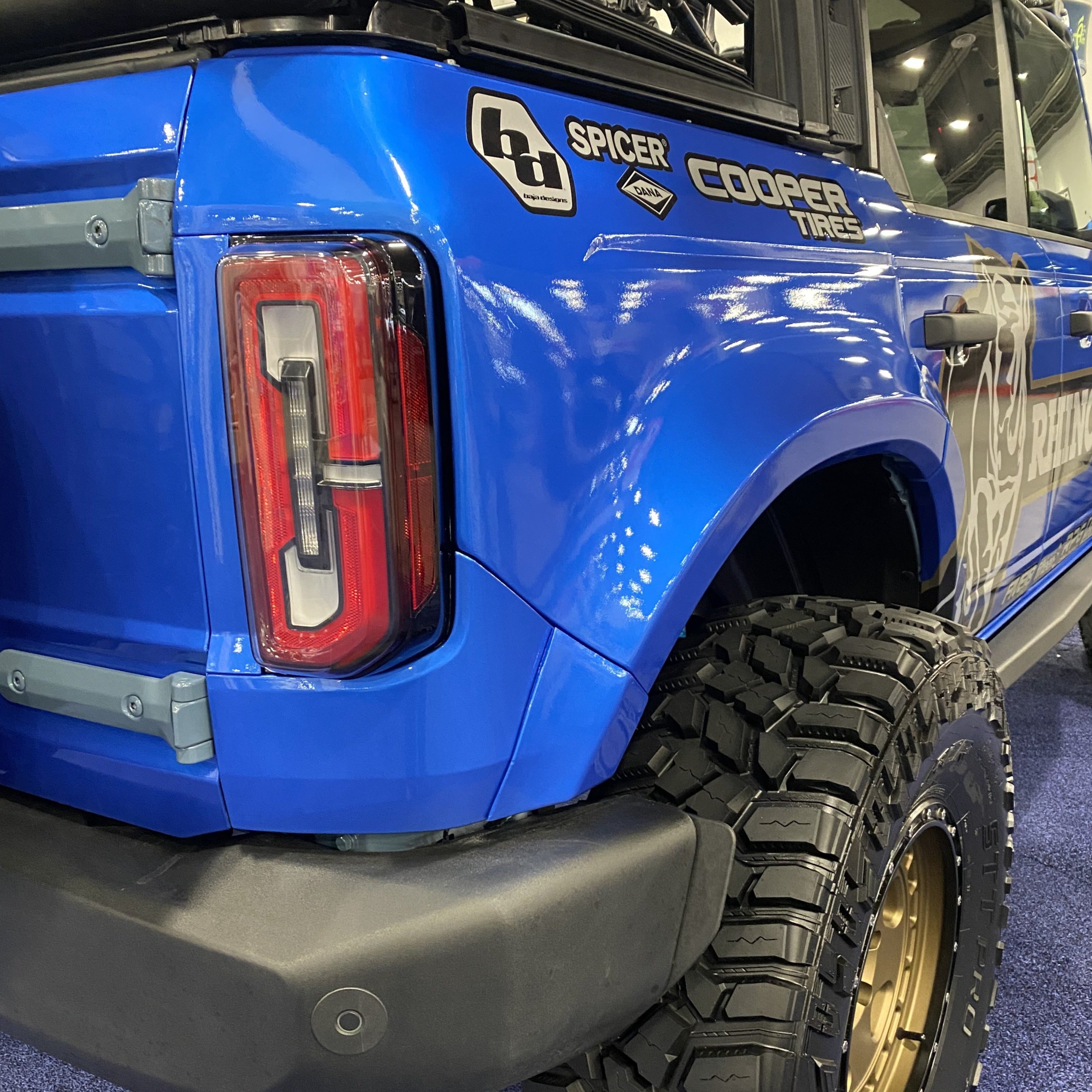 2021-2022 Ford Bronco 4-Door Rear Quarter Kit showcasing a blue exterior with offroad tires and custom branding.
