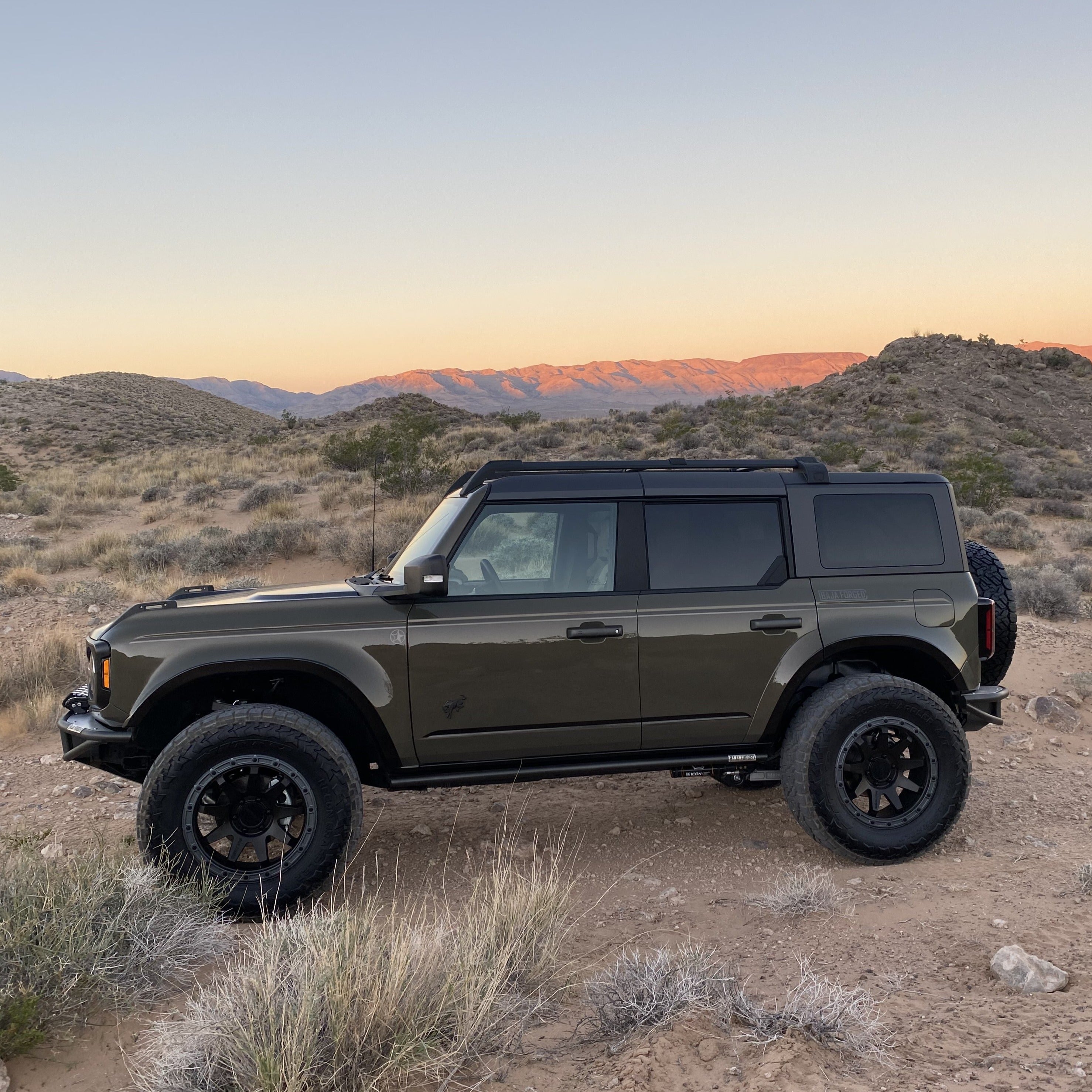 2021-2022 Ford Bronco with custom fenders parked in a desert landscape, showcasing its rugged offroad capabilities.