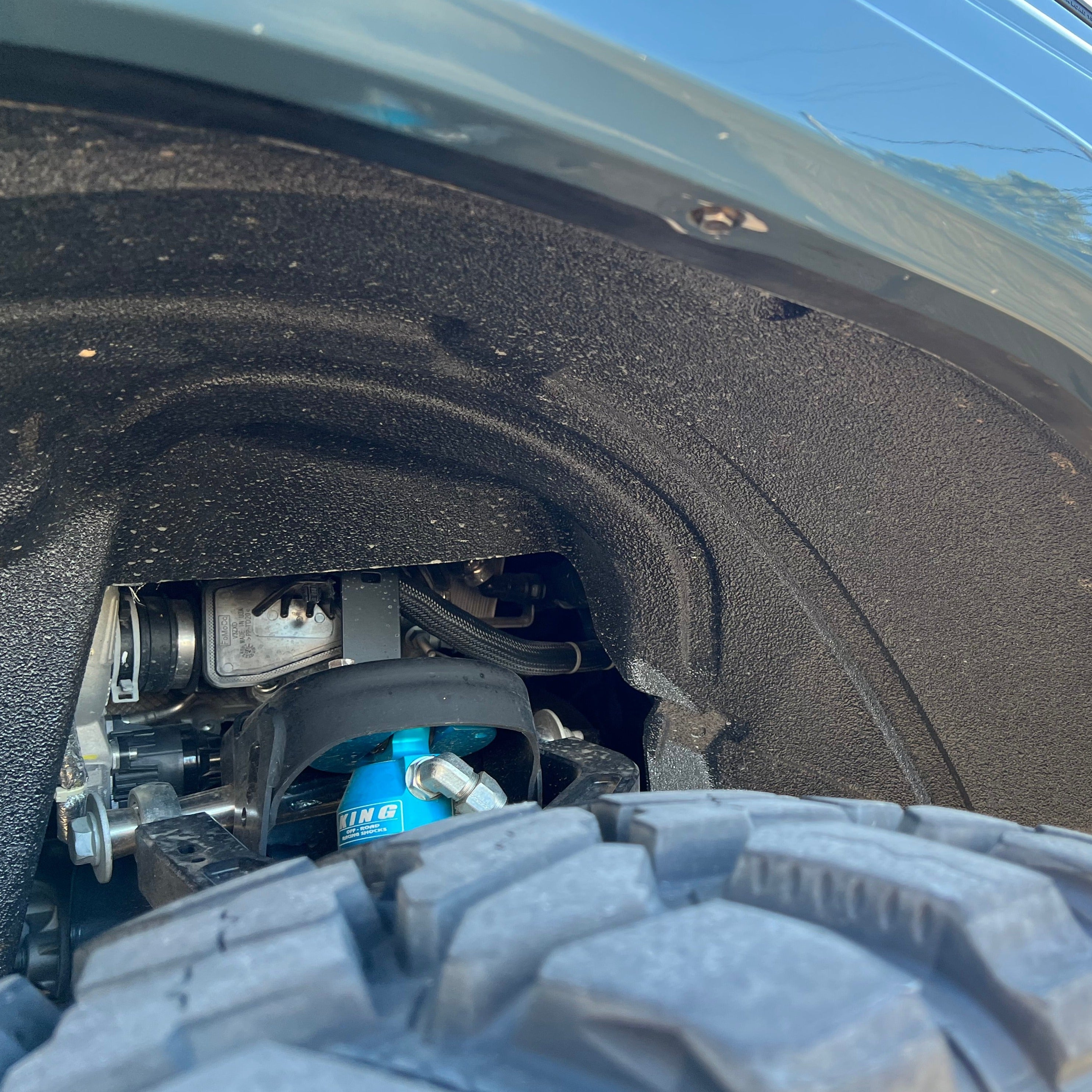Close-up view of 2021-2022 Ford Bronco fenders showcasing the tire clearance and suspension components.