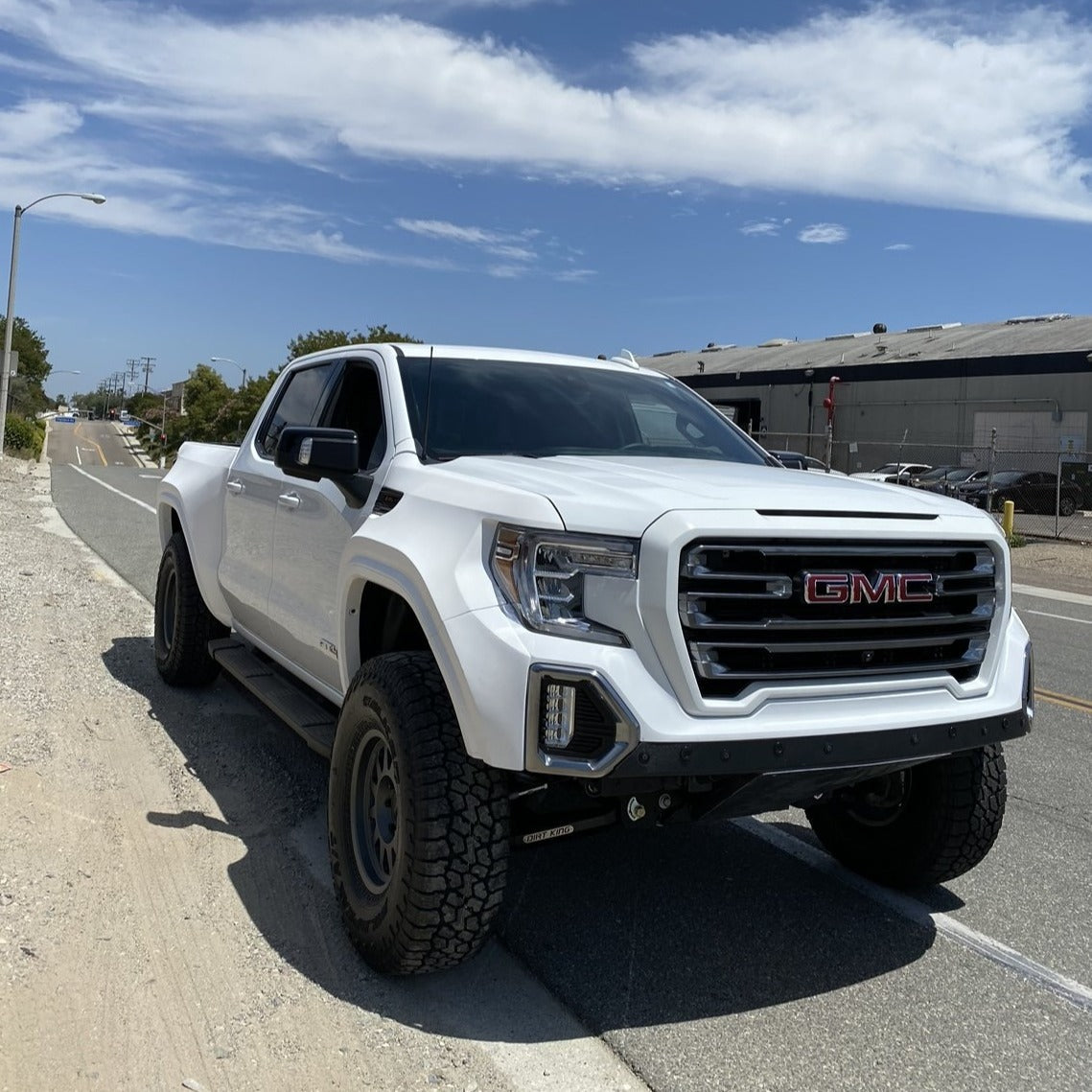 2019-2021 GMC Sierra with aftermarket bedsides, showcasing an offroad-ready design and rugged tires.