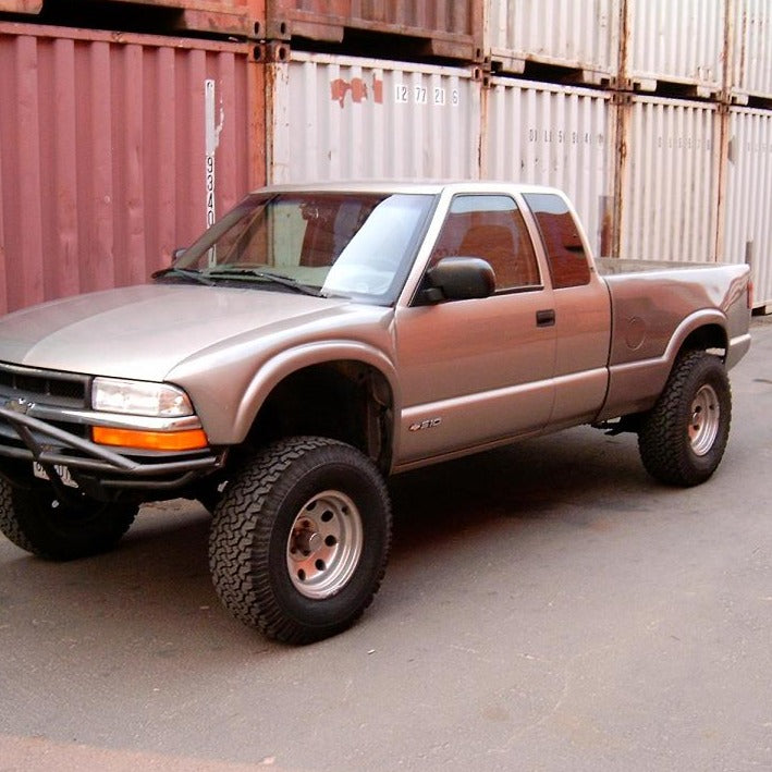 1994-2005 Chevrolet S-10 with lifted suspension and off-road tires, showcasing custom bedsides for enhanced performance.
